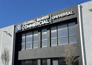 A sleek business sign displaying the Coldwell Banker Commercial logo and branding, showing professionalism and expertise