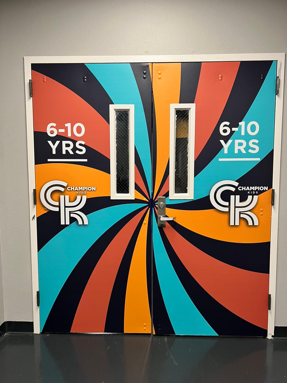 Champion Kids colorful door wrap by Uni Signs