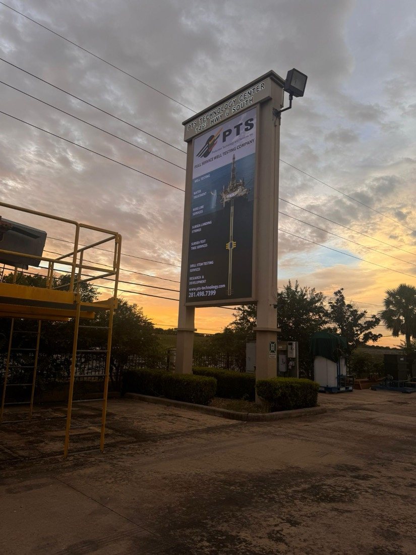 same pylon sign after refacing, illuminated at dusk - PTS Technology Center, Highway 6 South Houston