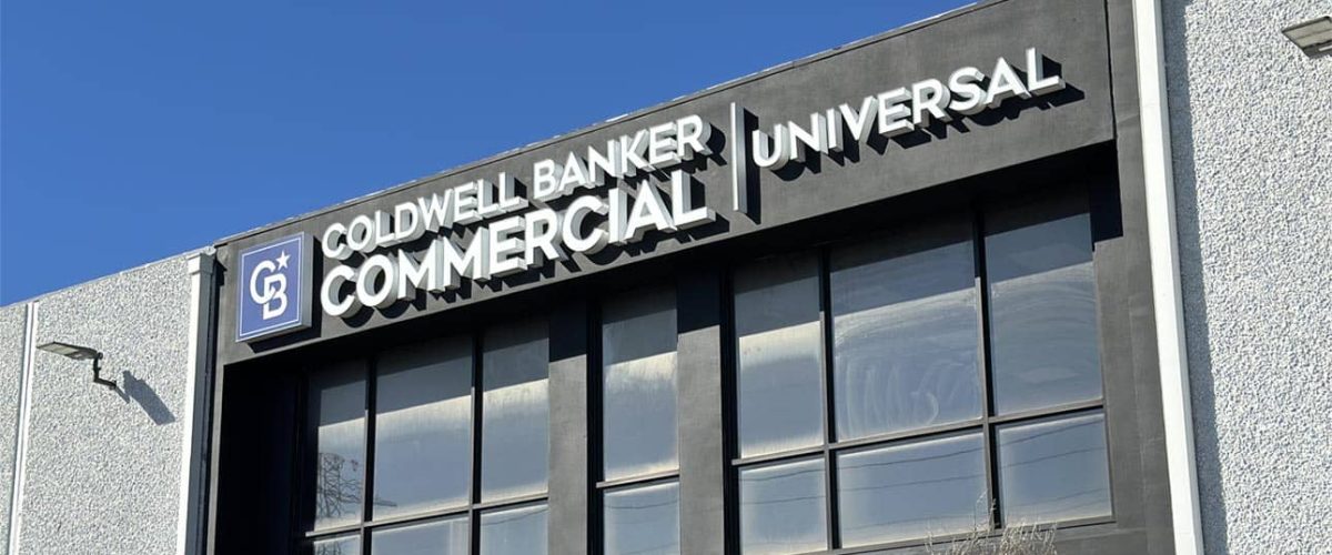 A sleek business sign displaying the Coldwell Banker Commercial logo and branding, showing professionalism and expertise